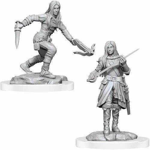Divas nekrāsotas pelēkas plastmasas D&D miniatūras: puscilvēka zagle ar arbaletu, dunci un zobenu uz apaļām pamatnēm.