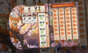 Kyoto no Neko galda spēles spēlētāja planšete ar kaķa ilustrāciju, prasmju attīstības skalu un punktu skaitīšanas laukumiem.