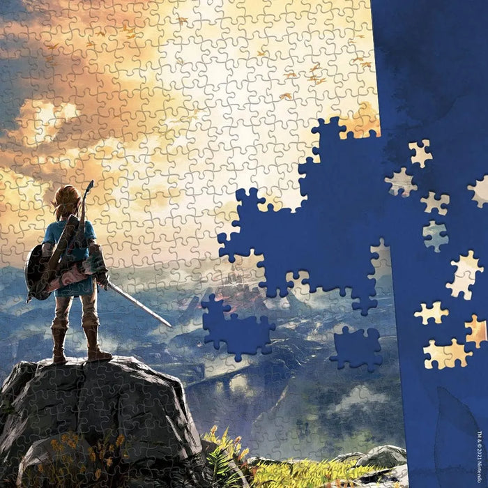 1000 gabaliņu The Legend of Zelda puzle ar Linku uz klints, 69x49 cm izmērā, krāsains fantāzijas dizains.